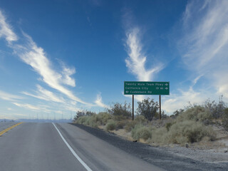 Roadside sign with directions to Twenty Mule Team Parkway, California City and Cuddeback Road in California.