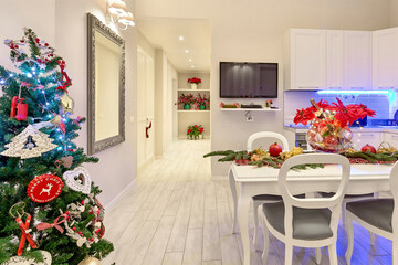 Beautiful xmas lights garland, decorated Christmas tree in a modern interior design.
