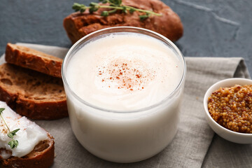Jar of lard spread on black background