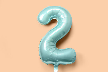 Balloon in shape of figure 2 on beige background