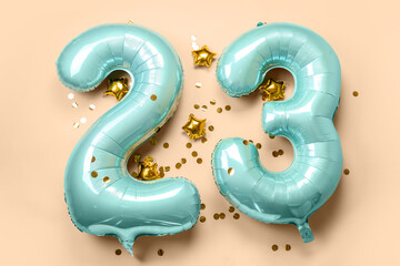 Figure 23 made of balloons and confetti on beige background - obrazy, fototapety, plakaty