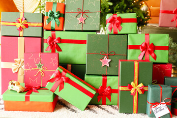 Many Christmas gift boxes on floor in room