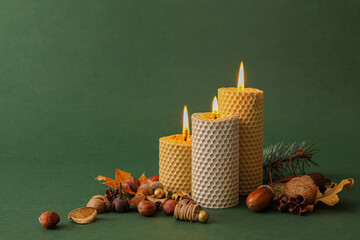 Burning candles and autumn decor on color background