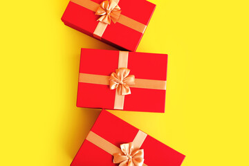 Red Christmas gift boxes on color background