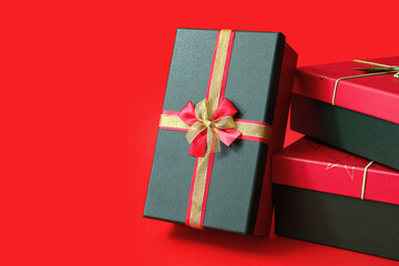 Stack of Christmas gift boxes on red background