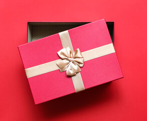 Opened gift box on red background