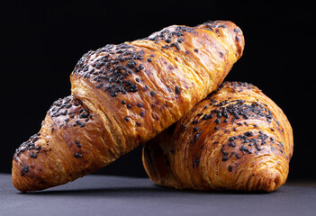 Croissants on a black background. Fresh cake and pastry.