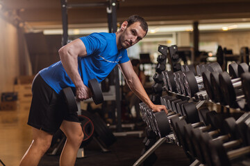 personal trainer exercising triceps with dumbbells