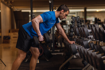 personal trainer exercising triceps with dumbbells