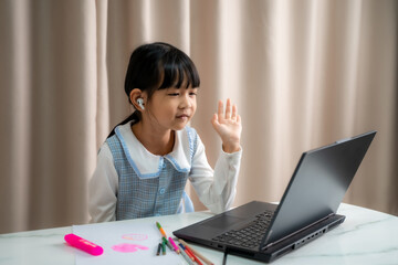 Girl in headphones study online using laptop at home,Child in earphones take Internet web lesson or...