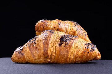 Croissants on a black background. Fresh cake and pastry.