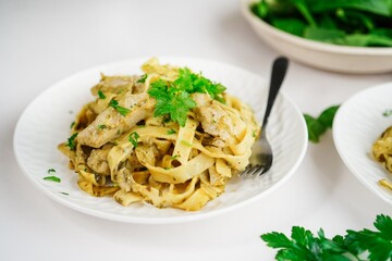 Homemade spinach  chicken Alfredo pasta on white background