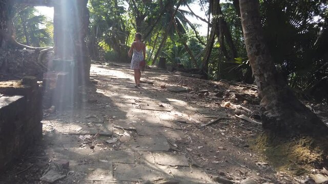 Tourist explores Ruined Colonial Buildings on Chandra Bose Island, Andaman Islands, India.