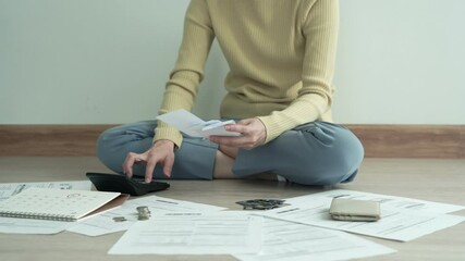 Women have severe stress due to debt. woman  is sitting at the press of various expense calculators on invoices and credit card debt. woman are no money with the debt to pay monthly. Debt concept.