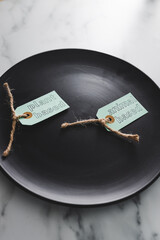 plant-based and animal-based product tags on top of black dining plate on marble table, healthy...
