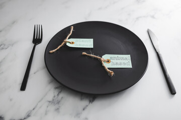 plant-based and animal-based product tags on top of black dining plate on marble table, healthy...