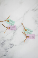 plant-based and dairy-free labels next to animal-based and dairy ones on top of marble table,...