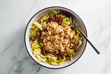 vegan green salad with quinoa and mashed chickpeas topped with dukkah and seasoning, healthy...