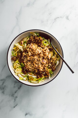 vegan green salad with quinoa and mashed chickpeas topped with dukkah and seasoning, healthy plant-based food