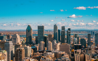 Montreal, Canada - November 10, 2021: Montreal skyline and buildings on a sunny fall day with clouds  - obrazy, fototapety, plakaty