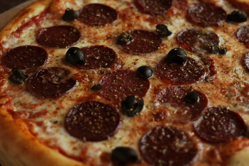 pepperoni pizza with salts and olives close-up