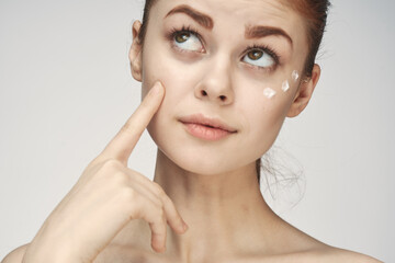 Obraz na płótnie Canvas woman with bare shoulders face cream skin care close-up