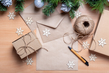 Gifts in handmade boxes, recycled paper, envelope, twine, artificial spruce branches and wooden...