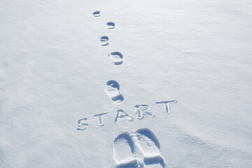 Concept inscription start and footprints in snow. New Year. Beginning. first step