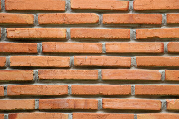 Old brick wall with orange color as the background.