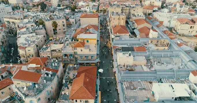 Jerusalem, Israel. Aerial View, People Walking on Street in Shuk Machane Yehuda Bazaar District, Traditional Marketplace at Evening, Drone Shot