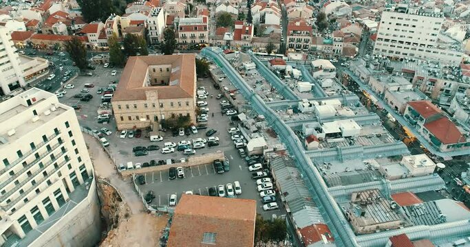 Shuk Machane Yehuda, Jerusalem, Israel, Drone Aerial View of Traditional Bazaar, Marketplace and Neighborhood Buildings, Dolly Pull Back