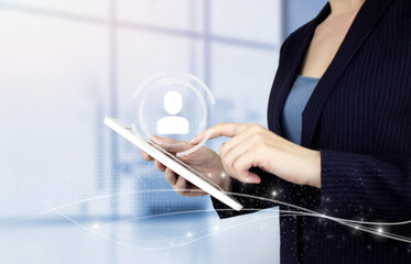 Naklejka premium HR Human Resources Recruitment Employment. Hand touch white tablet with digital hologram Human, Leader sign on light blurred background. Social media concept. Communication network.