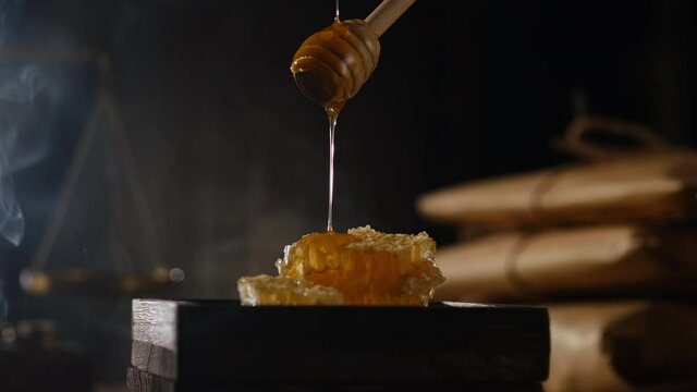 A closeup view of honey bee extract with smoke and lighting , for chinese traditional medicine advertising