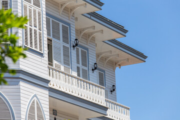Windows with white wooden shutters on wall building, Turkey