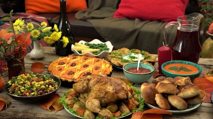 Thanksgiving holiday table. Traditional autumn dishes - turkey, homemade pumpkin pie, baked potatoes, buns. Family dinner at home. Harvest Festival