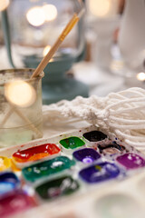 Set of watercolor paints and paintbrushes for painting closeup. Selective focus.