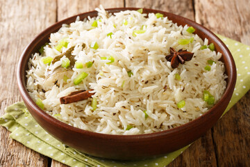 Jeera rice or cumin rice cooked with cumin seeds, cloves, cardamom, and bay leaf close up in the...