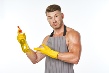 cheerful man in apron detergent posing muscles