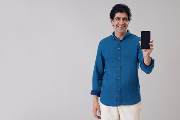 Indian man showing his smartphone in front of camera