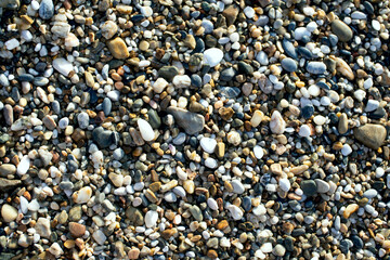 Real natural background: pile of shingles. Grey, brown and white pebbles.