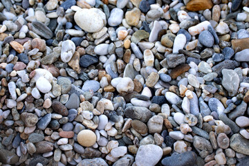 Fototapeta na wymiar Real natural background: pile of shingles. Grey, brown and white pebbles.