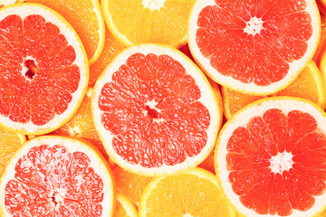 Slices of oranges and a grapefruits as a background.