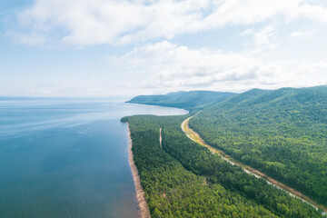 Fototapeta na wymiar Summertime imagery of Lake Baikal is a rift lake located in southern Siberia, Russia Baikal lake summer landscape view from a cliff near Grandma's Bay. Drone's Eye View.