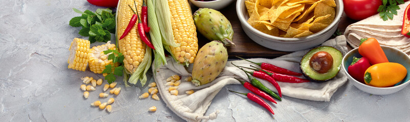 Mexican dishes and snacks assortment on light gray background.
