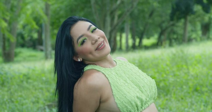Eyelashes close of a latin woman sitting on a log at the park