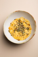 Bowl of yellow corn porridge with seeds