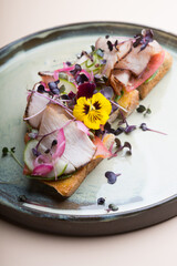 Ham toast bruschetta decorated with flowers and greens