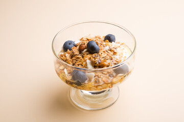 Bowl of granola oatmeal with bluberries and nuts for breakfast