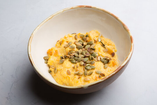 Bowl of yellow corn porridge with seeds