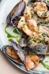 Plate of black seafood pasta with shrimps, mussels, squid